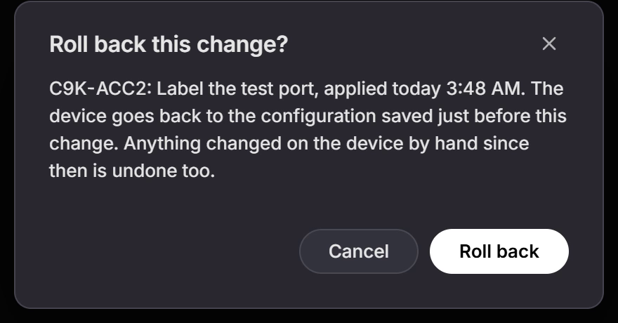 The Roll back this change? dialog: C9K-ACC2: Label the test port, applied today 3:48 AM. The device goes back to the configuration saved just before this change. Anything changed on the device by hand since then is undone too. With Cancel and Roll back buttons